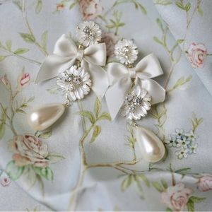 EMBELLISHED MOTHER OF PEARL + IVORY BOW EARRINGS BY NICOLA BATHIE